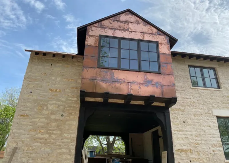 Copper metal panel facade on a stone building for Roof Repair in Brewer